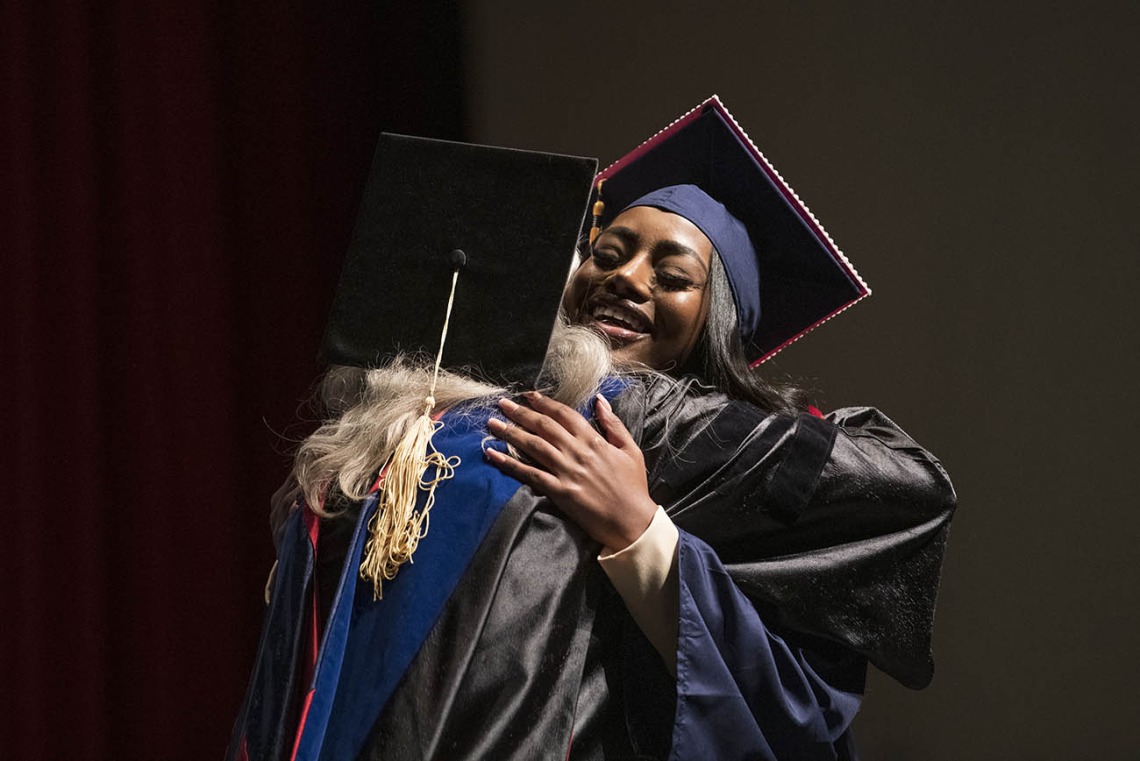 Jasmyn Countee (right) hugs Melissa Goldsmith, PhD, RNC, after being pinned and receiving her Bachelor of Science in Nursing during the UArizona College of Nursing 2022 spring convocation at Centennial Hall.¬