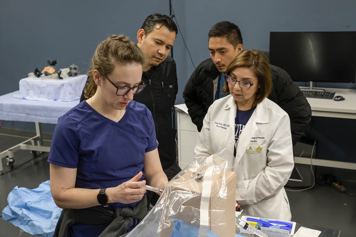 University of Arizona College of Nursing Doctor of Nursing Practice students practice a spinal block on a manikin during a clinical immersion session.
