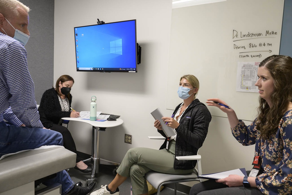 A patient answers questions from UArizona Doctor of Nursing Practice students during a clinical immersion session.