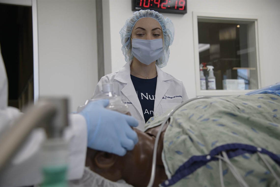 Anastasia Connelly, RN, a second-year CRNA resident, plays the role of an OR nurse during a critical skills simulation at the Arizona Simulation Technology and Education Center. 