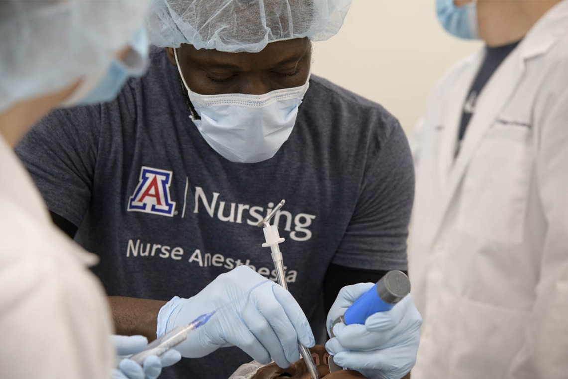 CRNA student Olu Bello, RN, intubates a manikin during a crisis management clinical skills intensive simulation in the Arizona Simulation Technology and Education Center. 