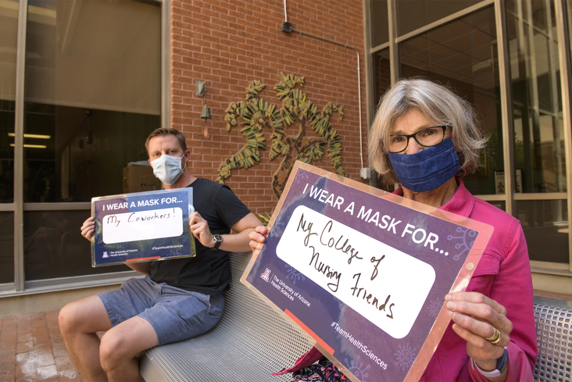 Motivated to protect others. From left: Will Holst, director of marketing and communications, Ida M. “Ki” Moore, PhD, RN, FAAN, dean of the College of Nursing.