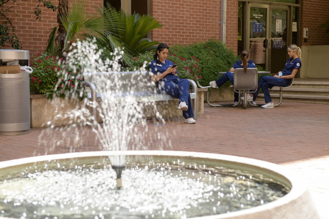 A patch of shade and the sound of running water make the courtyard at the College of Nursing a favorite place for people to get outside, even in the summer.