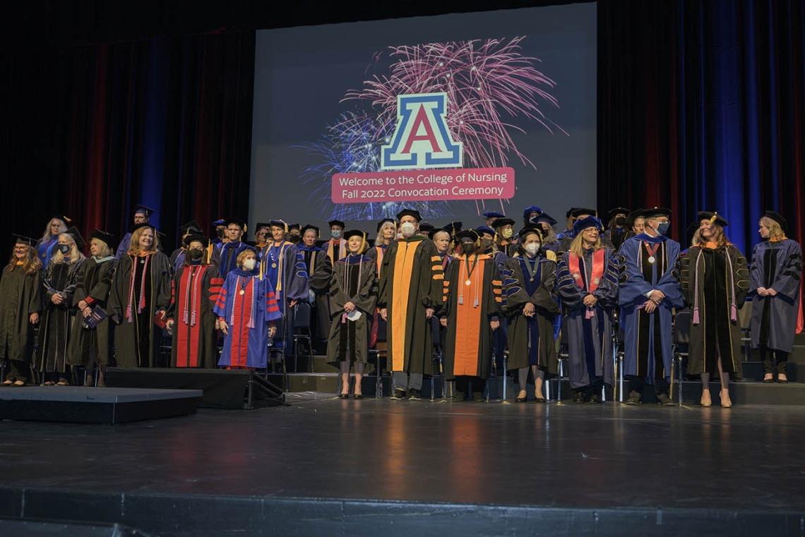 Michael D. Dake, MD, (center) senior vice president for the University of Arizona Health Sciences, is surrounded by College of Nursing faculty members at the college’s fall convocation at Centennial Hall on Dec. 15. 