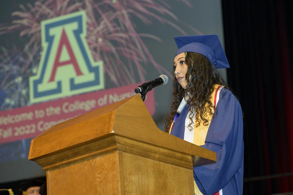 Mariafernanda Osornio, who earned a Bachelor of Science in Nursing – Integrative Health, gives the Spanish language welcome to attendees at the UArizona College of Nursing fall convocation in Centennial Hall on Dec. 15. 