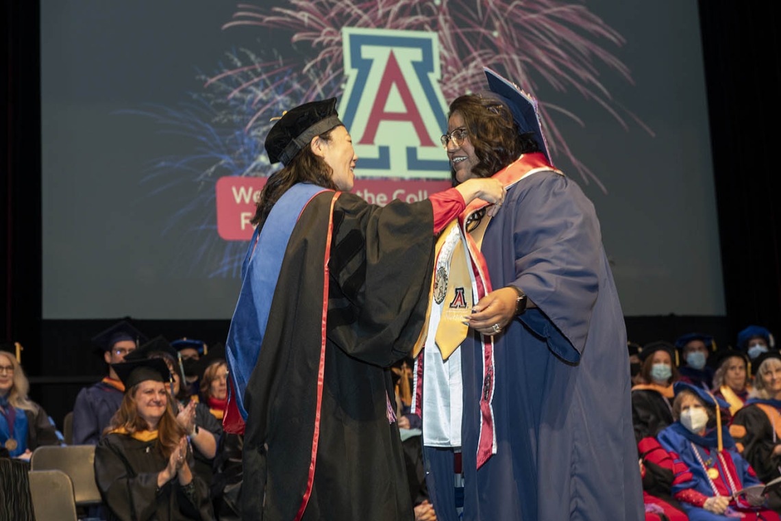 (From left) Assistant clinical professor Sharon Hom, PhD, MS, RN, presents Angela Acuna with the UArizona College of Nursing INCATS Program award at the college’s fall convocation at Centennial Hall on Dec. 15.