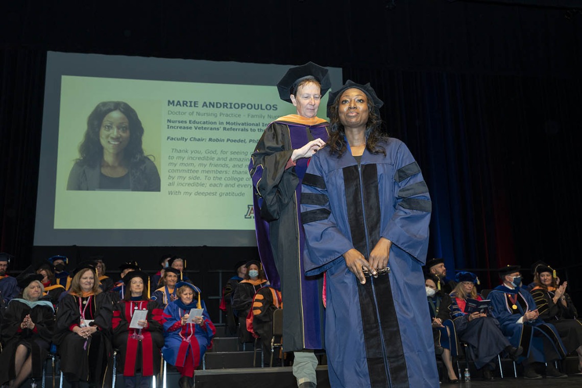 Doctor of Nursing Practice graduate Marie Andriopoulos is hooded during the UArizona College of Nursing fall convocation by assistant clinical professor Robin Poedel, PhD, RN, FNP-BC.