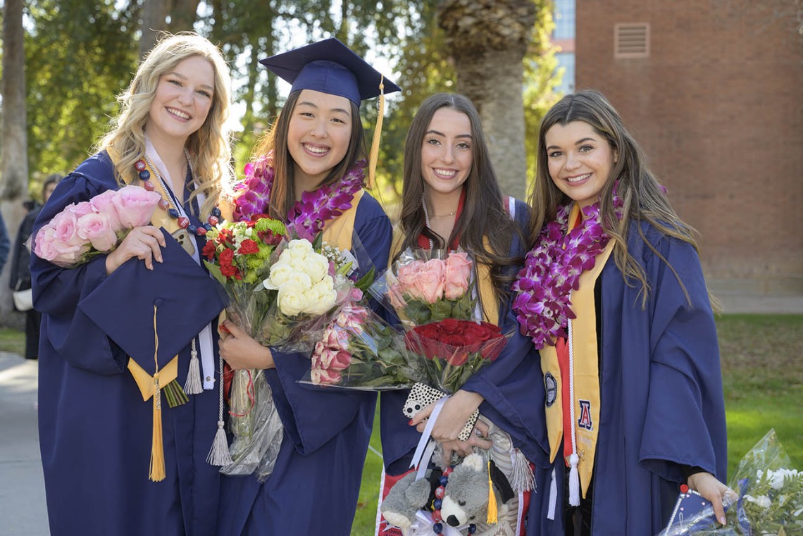 (From left) UArizona College of Nursing Bachelor of Science in Nursing – Integrative Health graduates Tiffany Kalk, Eunice Jung, Sydney Johnson and Gigi Steiner pause for a photo outside of Centennial Hall after the college’s convocation. 