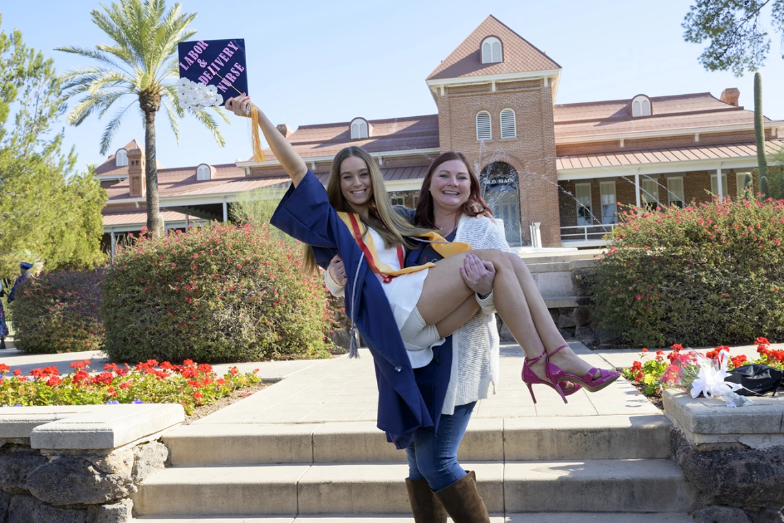 Bachelor of Science in Nursing – Integrative Health graduate Riley Kuderca celebrates with her friend Amanda Regrendele at the UArizona College of Nursing fall convocation.