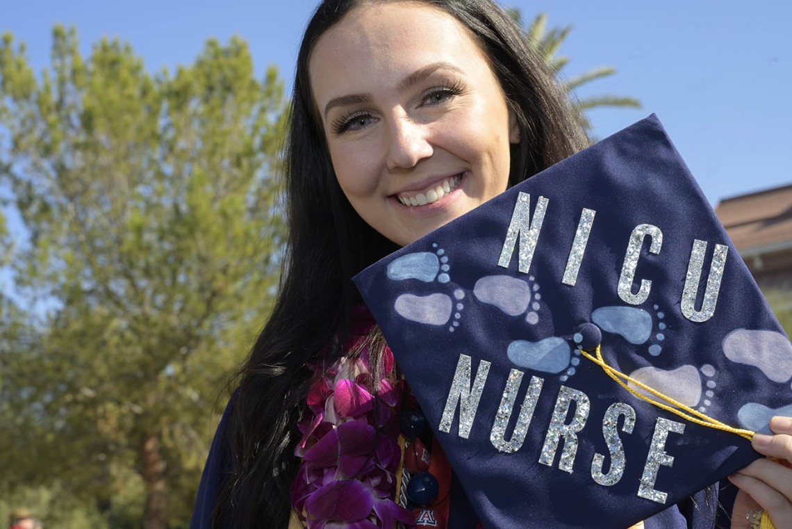 Madelyn Askew shows her decorated mortarboard after   receiving her Bachelor of Science in Nursing – Integrative Health degree at the UArizona College of Nursing fall convocation at Centennial Hall on Dec. 15.