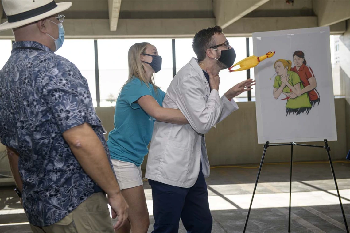 College of Medicine – Phoenix students Jennifer Codd and Erik Garber demonstrate the Heimlich maneuver, how to help someone who is choking. 