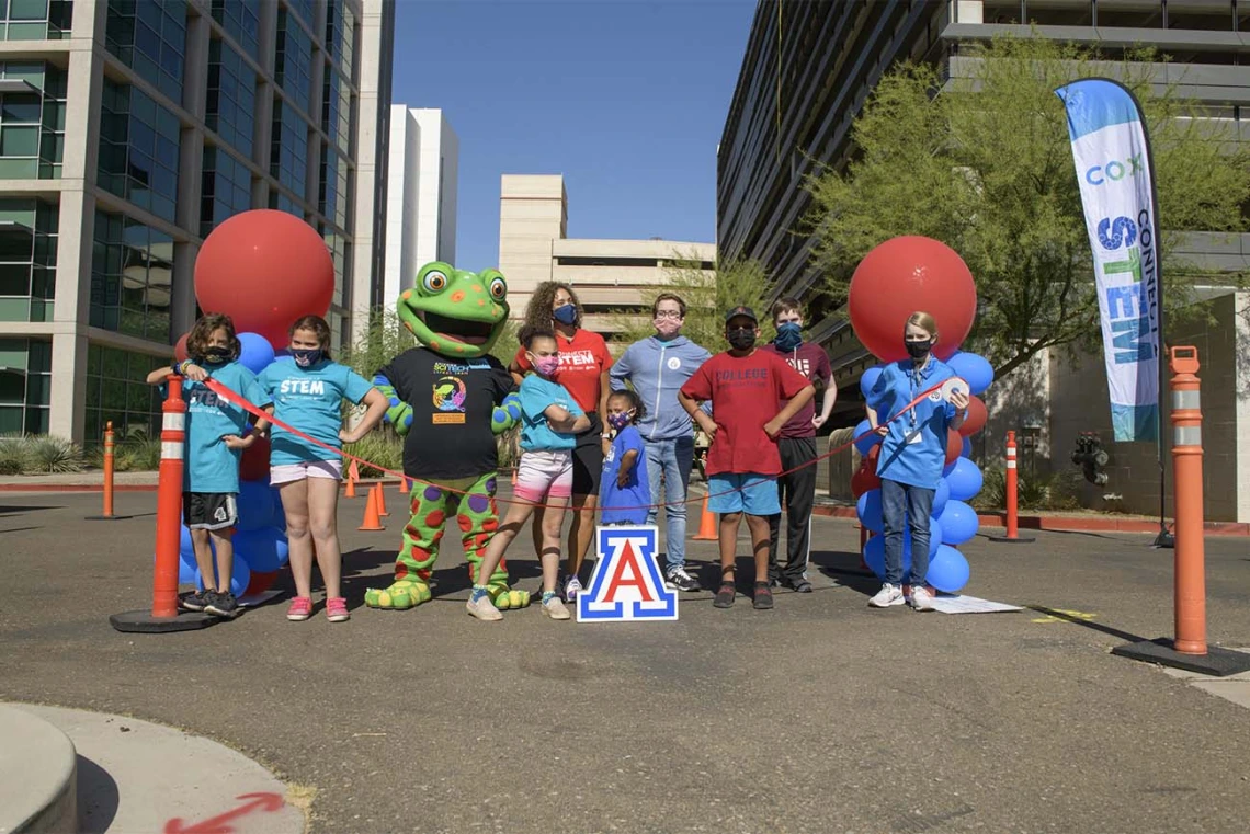 Volunteers and University of Arizona Health Sciences staff stand ready to open the 2021 Connect2STEM drive-through event at the Phoenix Biomedical Campus parking garage.