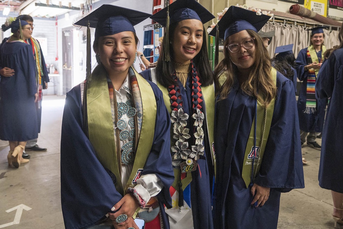 Bachelor of Science in Pharmaceutical Sciences graduates (from left) Rolonda Slim, Cielo Perez and Aimee Nguyen pause for a photo backstage in Centennial Hall before the start of the R. Ken Coit College of Pharmacy 2022 spring convocation.