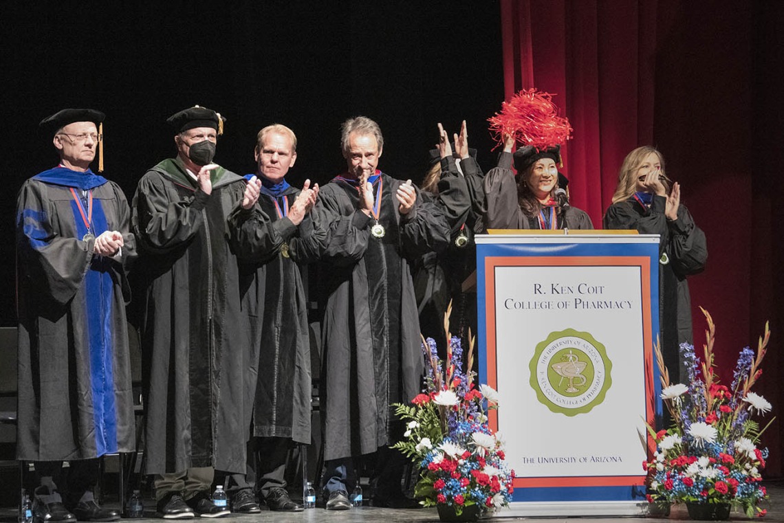 UArizona Health Sciences Senior Vice President Michael D. Dake, MD, (second from left) joins the R. Ken Coit College of Pharmacy faculty and staff in cheering on graduating students as they walk into Centennial Hall at the start of the 2022 spring convocation at Centennial Hall. 