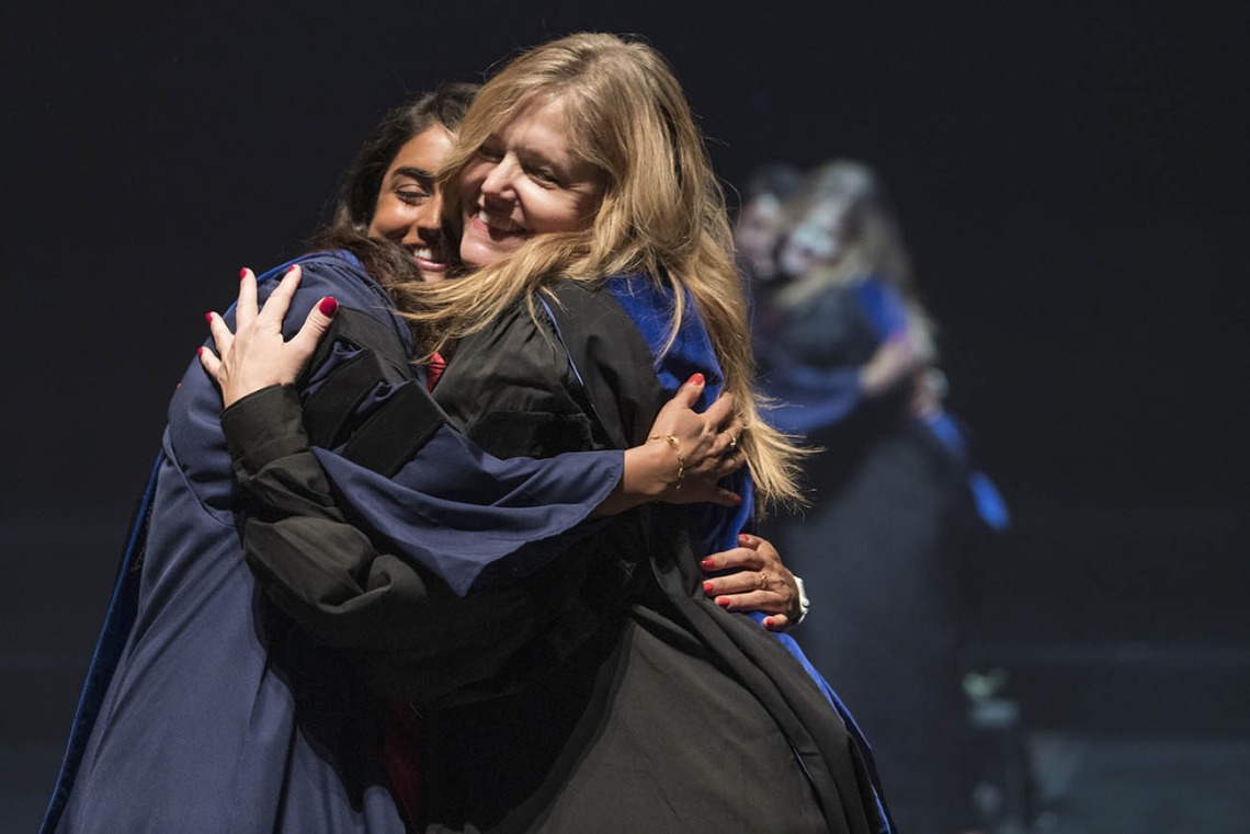 Srujitha Marupuru, PhD, hugs her advisor Terri Warholak, PhD, RPh, after being hooded for earning her Doctor of Philosophy degree in pharmacology and toxicology during the R. Ken Coit College of Pharmacy 2022 spring convocation at Centennial Hall.