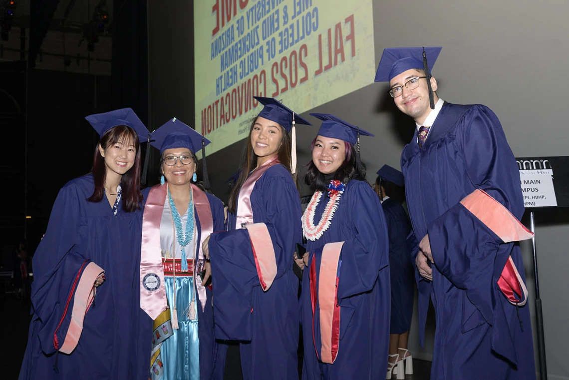 (From left) Master of Public Health graduates Sue Kim, Breanna Lameman, Geneva Frank, Kaitlyn Aoki and Samuel Farrow pause backstage at Centennial Hall before walking on stage to be hooded during the Mel and Enid Zuckerman College of Public Health fall convocation. 
