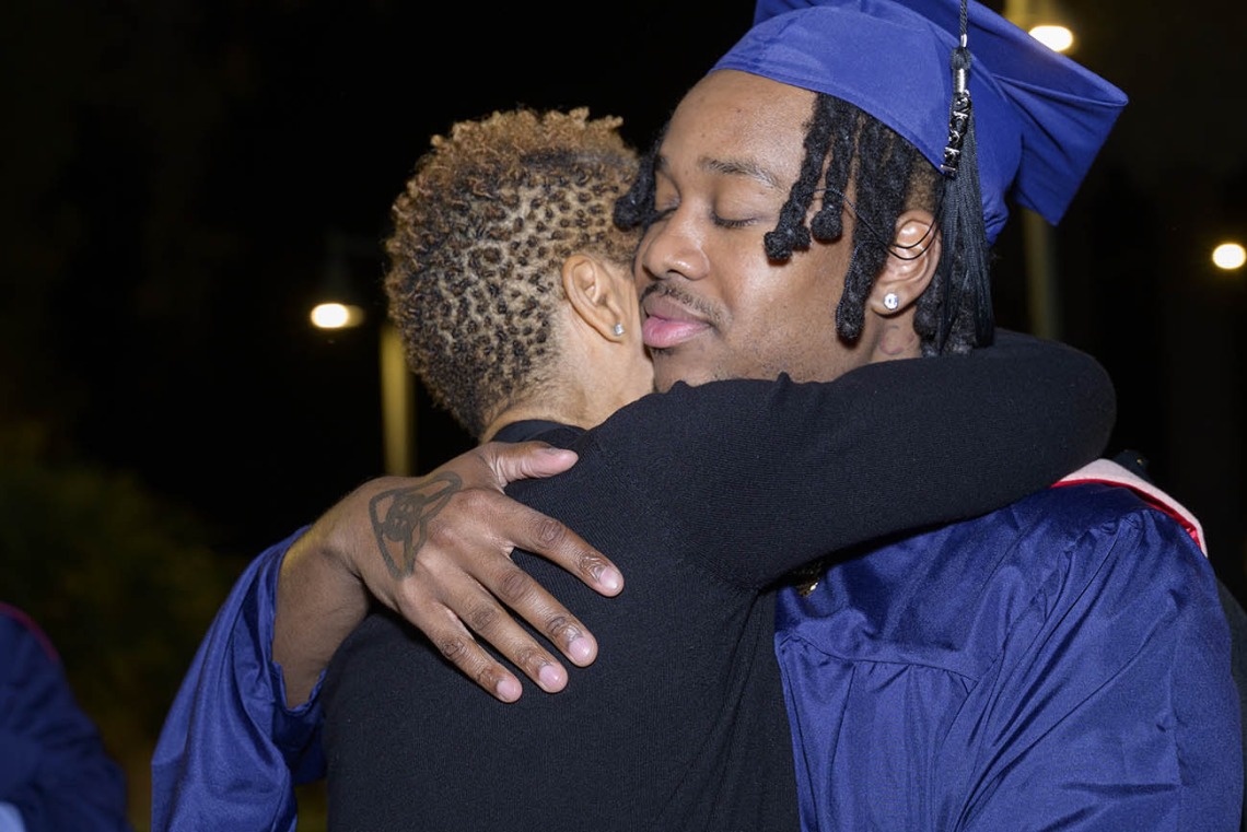Master of Public Health graduate Malcolm Wilson hugs his mother, LaTonya Price, after the Mel and Enid Zuckerman College of Public Health fall convocation. 