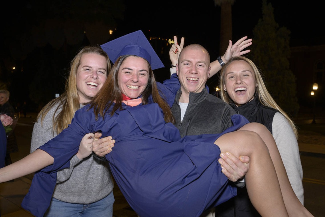 Casey McCormick celebrates earning her Master of Public health degree with friends (from left) Emma Strand, Nick Palumbo and Ingrid Freeman after the Mel and Enid Zuckerman College of Public Health fall convocation.