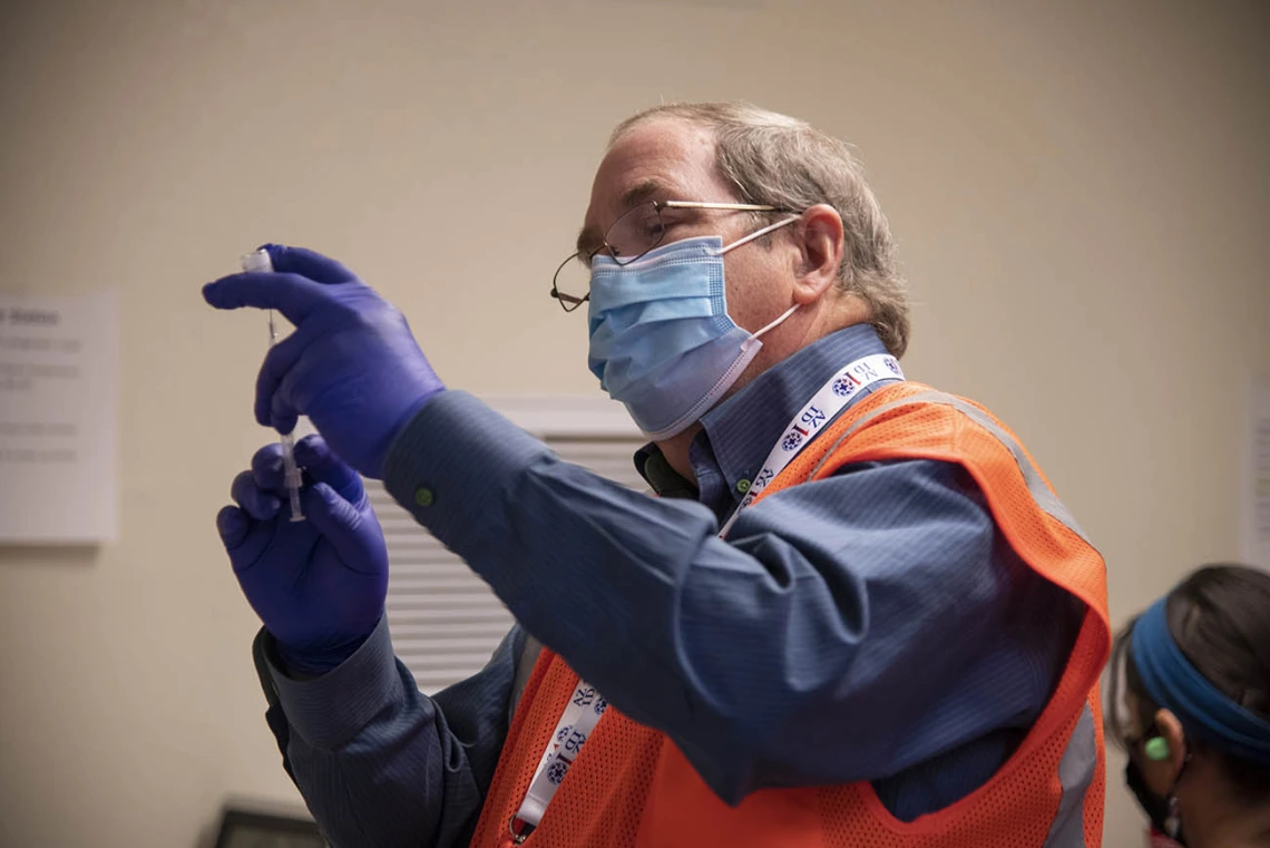 College of Pharmacy professor David Nix, PharmD, prepares the Pfizer COVID-19 vaccine for the Pima County drive-through Point of Distribution (POD) at the University of Arizona.