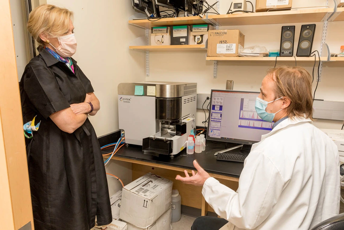 Deborah Birx, MD, coordinator of the White House Coronavirus Task Force, talks with a scientist during a recent tour of laboratories. The tour focused on the labs testing antibody and antigen samples collected from students and employees.