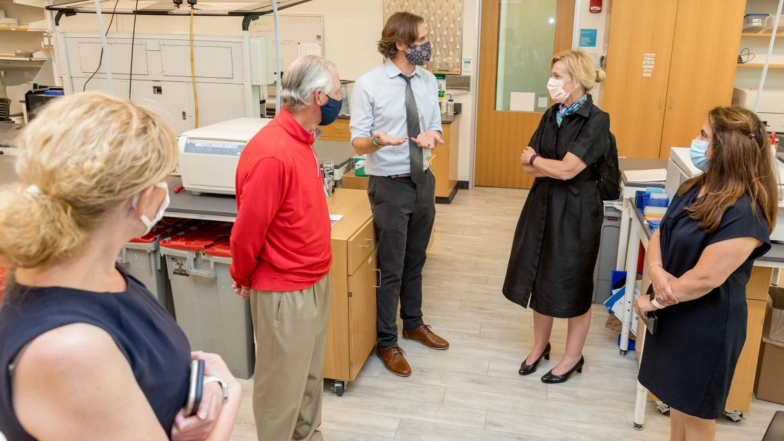 Deborah Birx, MD, coordinator of the White House Coronavirus Task Force, visited University of Arizona and UArizona Health Sciences laboratories where researchers are testing antibody and antigen samples collected from students and employees. Ryan Sprissler, PhD, staff scientist and manager of the UArizona Genetics Core, speaks with Dr. Birx as UArizona President Robert C. Robbins, MD, and others, listen.