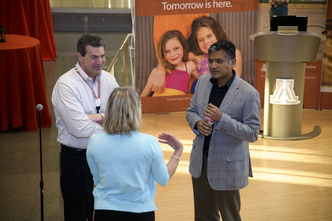 (From left) Mark Lane, former associate vice president of communications for UArizona Health Sciences, and his wife, Faith, talk to Deepta Bhattacharya, PhD, professor of immunobiology in the University of Arizona College of Medicine – Tucson, after his presentation at the first Tomorrow is Here Lecture Series event in Tucson. 