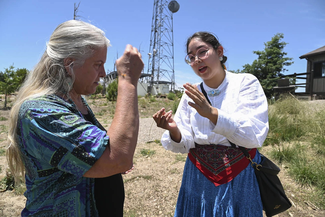 Kathleen Rodgers, PhD, professor of Pharmacology at the College of Medicine – Tucson (left) and Diné College program manager Kaitlyn Haskie (right) discuss the properties of a plant specimen found at Mt. Lemmon.