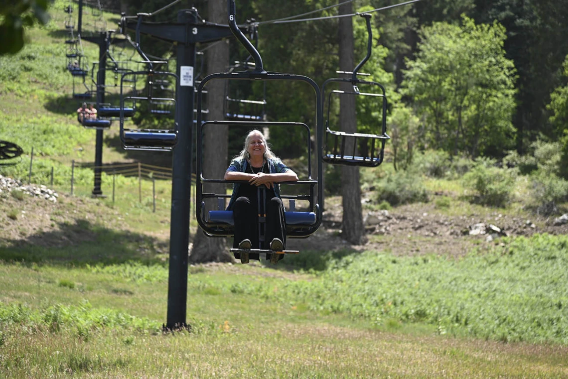 Kathleen Rodgers, PhD, professor of Pharmacology at the College of Medicine – Tucson, takes in the scenery and cooler mountain temperatures while riding the ski lift at Mt. Lemmon during a trip with students from the URBRAIN program.