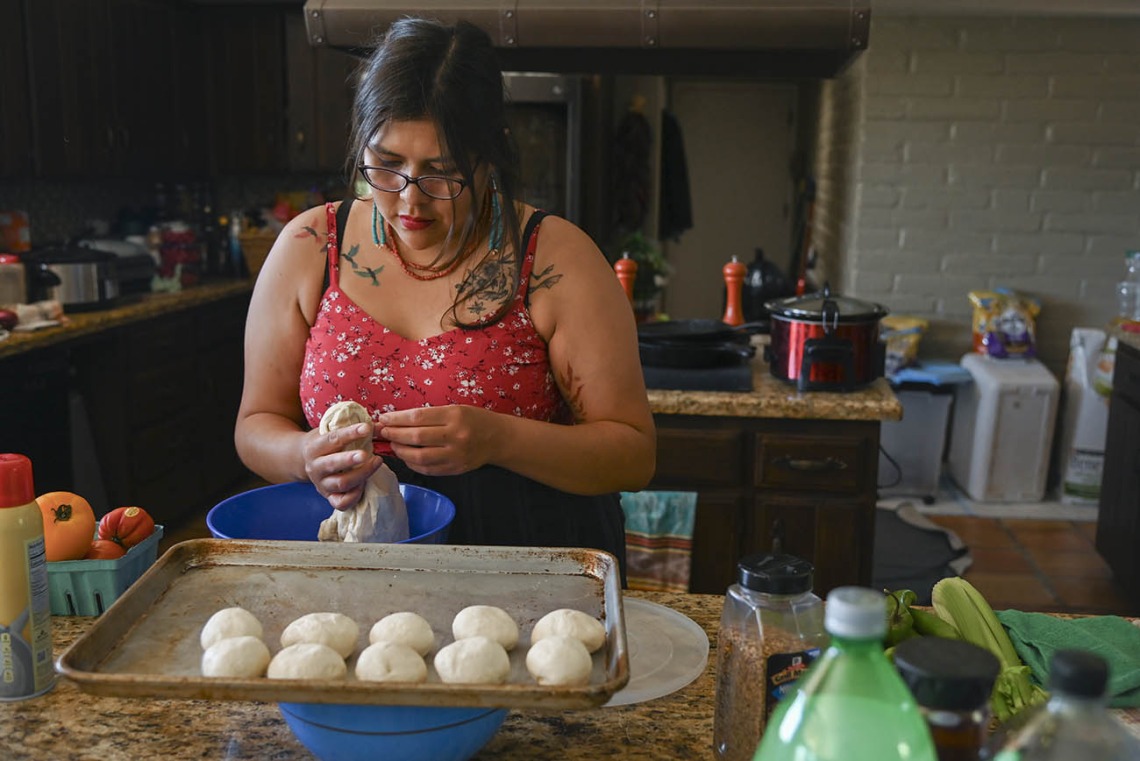 Diné College student Alyssa Joe prepares fry bread for a dinner with colleagues from the Center for Innovation in Brain Science, where she took part in a 10-week neurosciences program. 