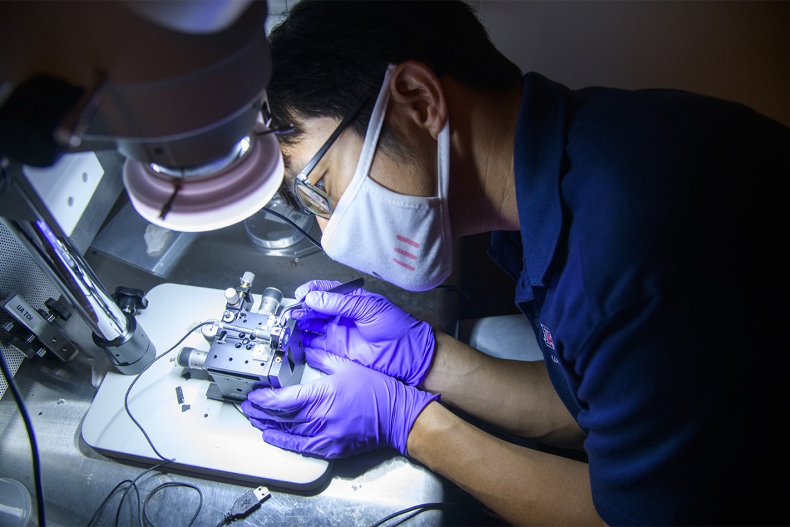 Dongkyun Kang, PhD, has created a portable prototype of a microscope used to help diagnose skin cancer. Here, he works to improve the device assembly.