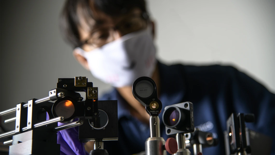 Dongkyun Kang, PhD, works on the laser light portion of a new, portable skin cancer diagnostic technology he is developing with Clara Curiel-Lewandrowski, MD.