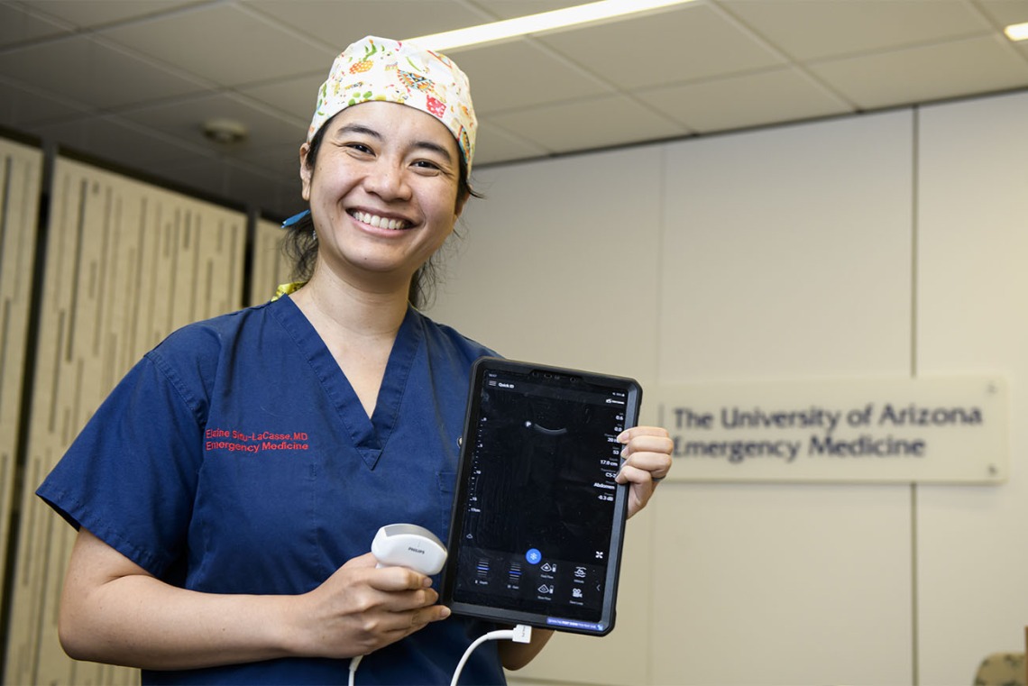 Holding a bedside ultrasound device, Elaine Situ-LaCasse, MD, a UArizona College of Medicine – Tucson assistant professor, won a grant to train rural providers on lung ultrasound as a quicker, more efficient way to evaluate patients who may have COVID-19.