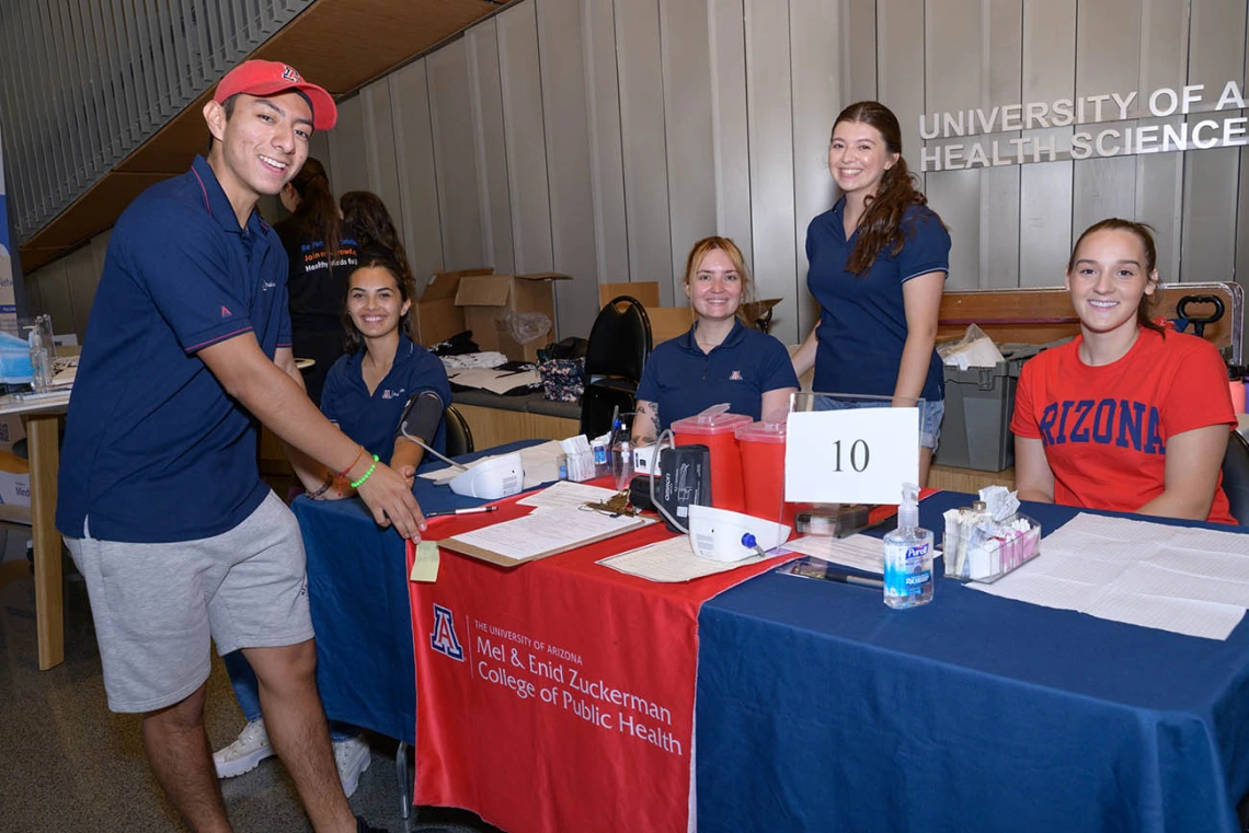 Students volunteer at the Mel and Enid Zuckerman College of Public Health information table during the inaugural Feast for Your Brain community event on Sept. 10. 