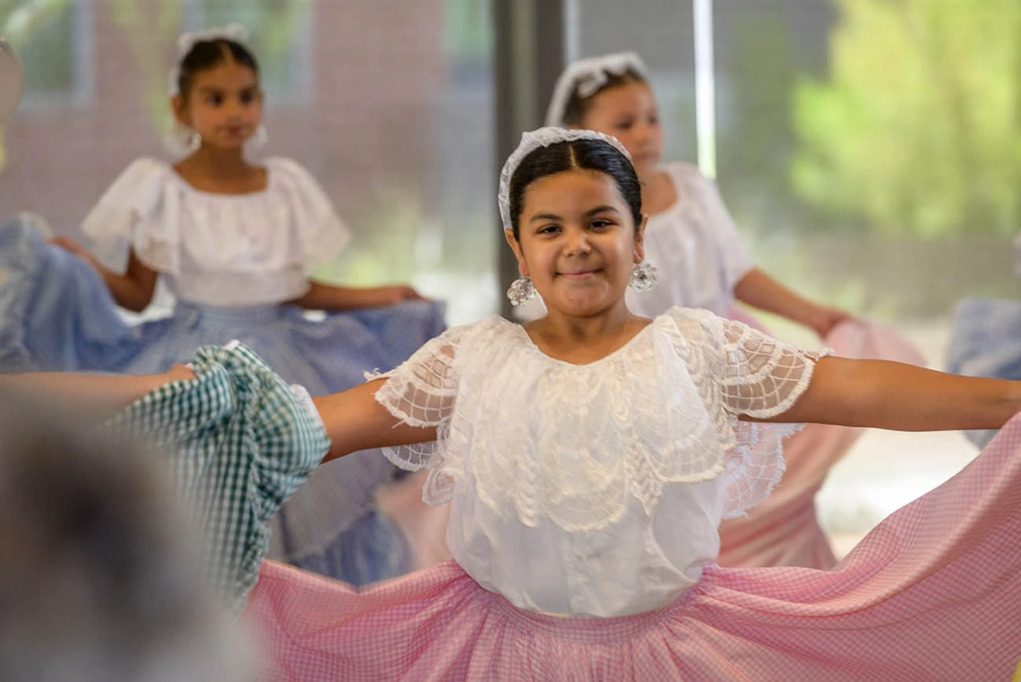 Gabby Mendez smiles at her parents as she dances with the Ballet Folklorico Tapatio group during the Feast for Your Brain community event. 