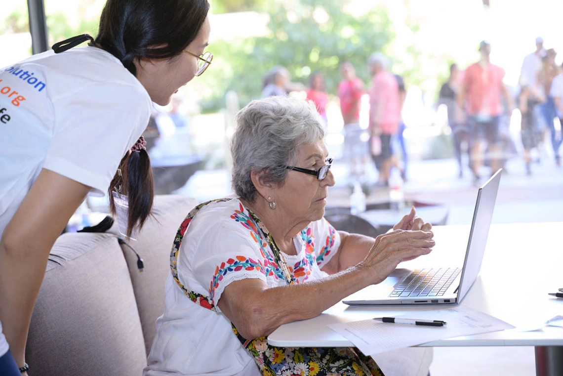 (From left) Gabby Wen, a graduate research assistant in the Mel and Enid Zuckerman College of Public Health, helps Bobbie Herrera as she prepares to take the MindCrowd memory test during the Feast for Your Brain community event on Sept. 10.