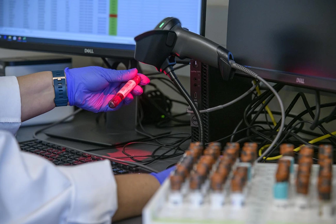 Lab technician Gina Delgado registers blood samples before they are processed to determine if they show antibodies to the virus that causes COVID-19.