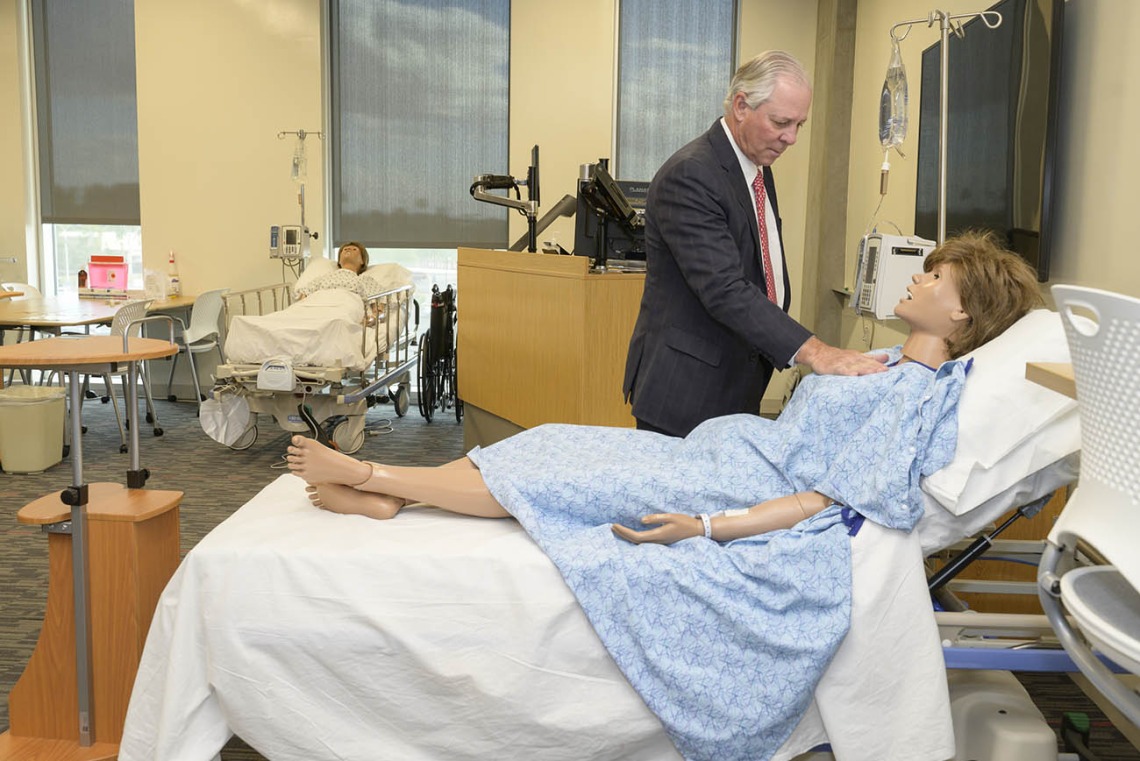 University of Arizona President Robert C. Robbins, MD, an internationally recognized cardiac surgeon, checks the simulated heart rate of a manikin in the College of Nursing’s renovated third-floor simulation lab in Gilbert, Arizona.