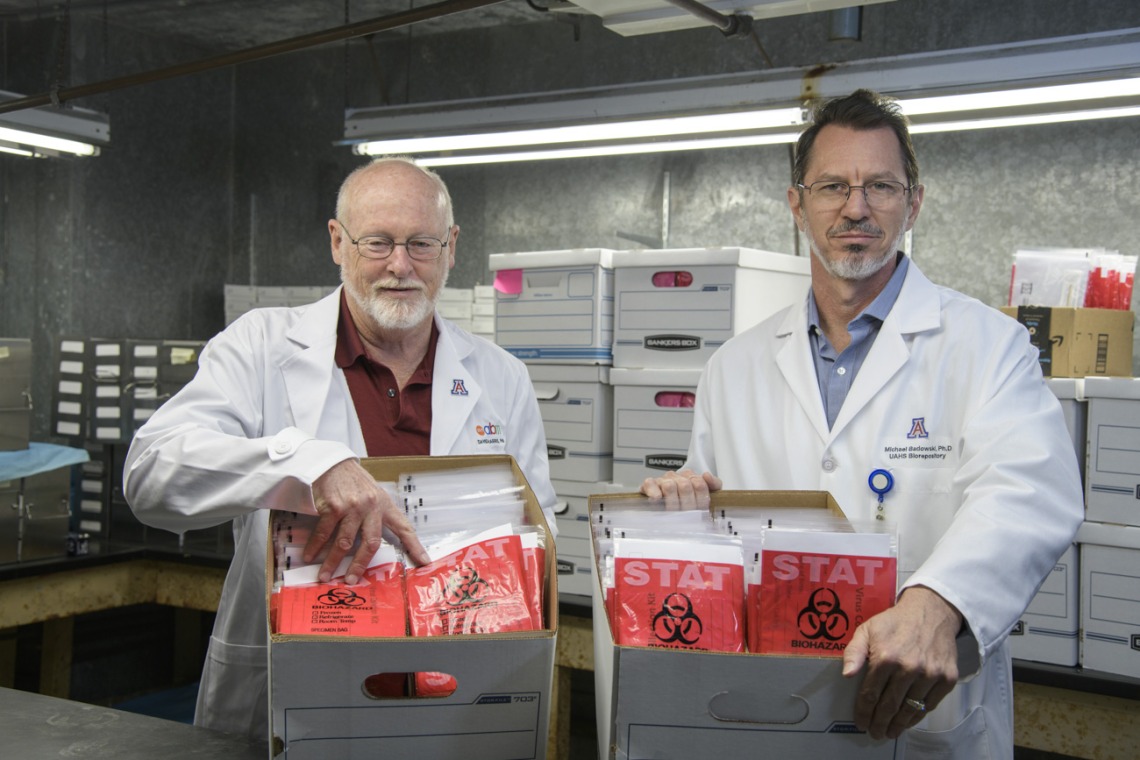 David T. Harris, PhD, (left) and Michael Badowski, PhD, (right) created sample collection kits to help alleviate the shortage of COVID-19 testing capabilities in March and April. The kits shown are ready for delivery to Arizona health care providers to test patients for COVID-19. The group was planning to produce approximately 5,000 sample collection kits per week, and delivered 1,000 of them to Banner-University Medical Center Tucson in early April.