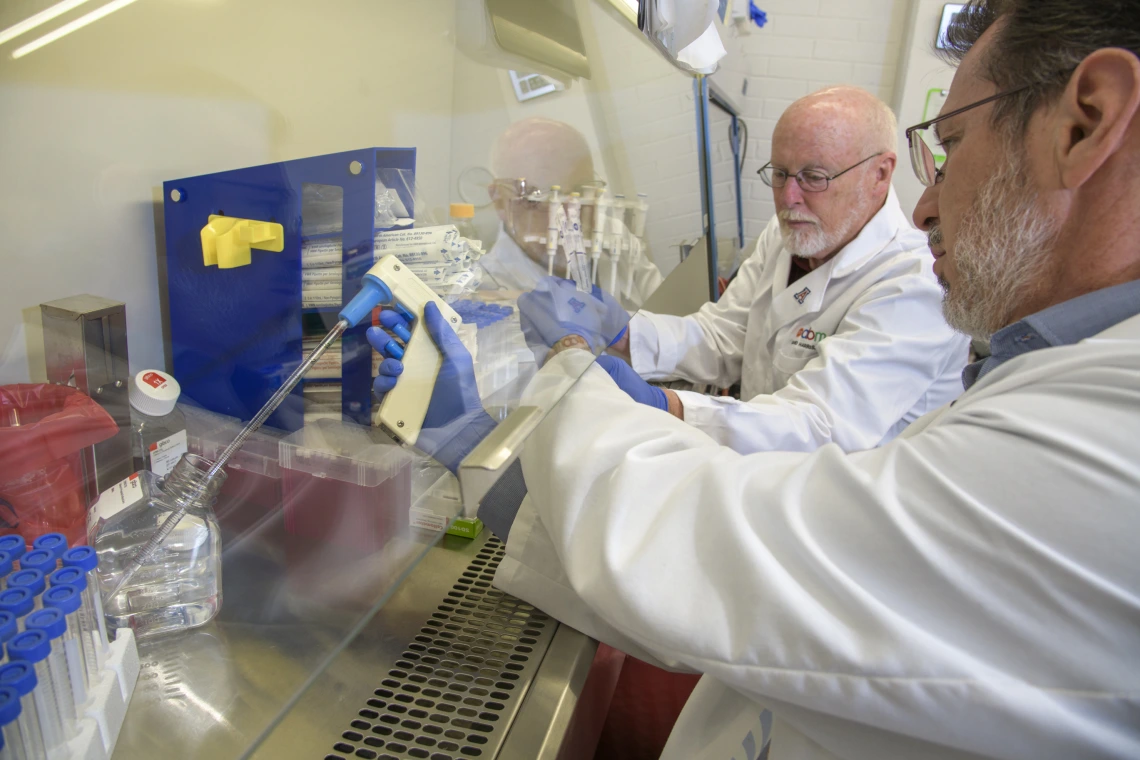 David Harris, PhD, MS, director of the University of Arizona Biorepository, and Michael Bawdowski, PhD, associate research scientist, prepare COVID-19 sample collection kits.