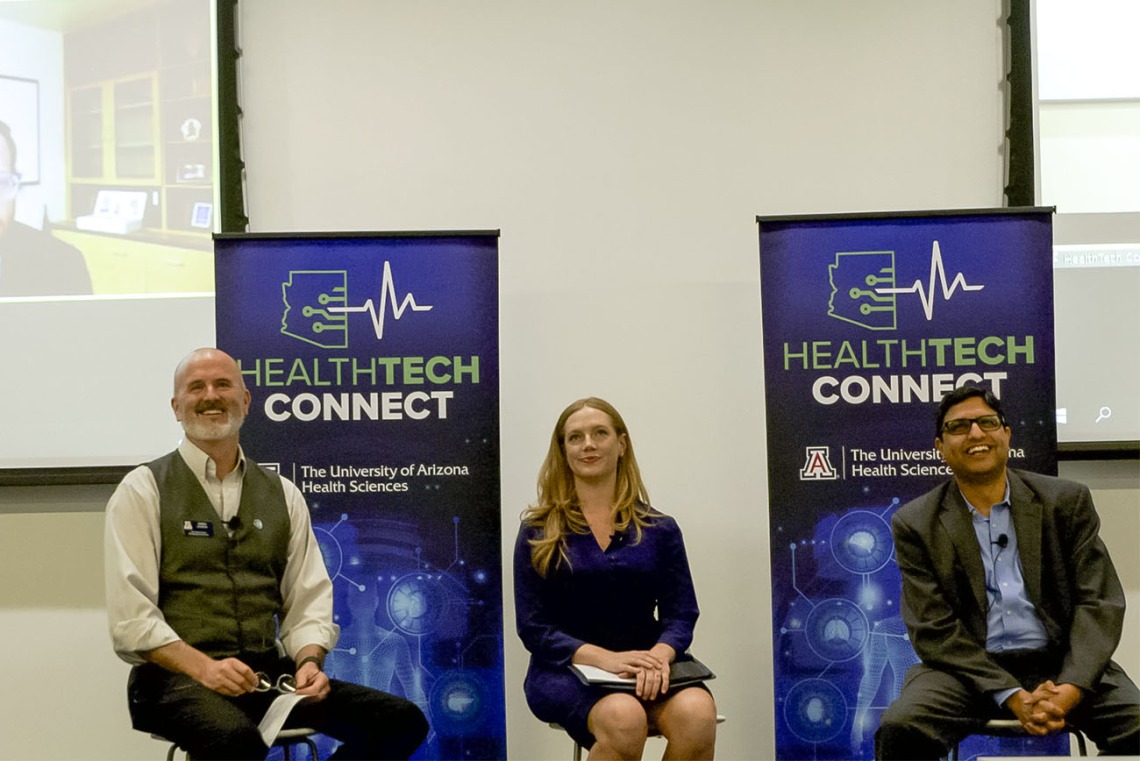 Doug Hockstad (left) of TechLaunch Arizona, facilitated a panel discussion on working with hospital systems and insurers. The panel included Kiran Avancha, PhD, RPh, (right) HonorHealth Research and Innovation Institute, Rachel Mertensmeyer, Rivia Health, and on screen,  Ryan Harper, Tenet Healthcare.