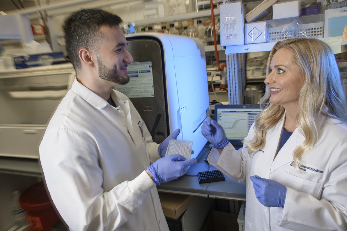 Melissa Herbst-Kralovetz, PhD, discusses research findings with Michael Khnanisho, a member of her research team at the University of Arizona College of Medicine – Phoenix and premed student at Arizona State University.