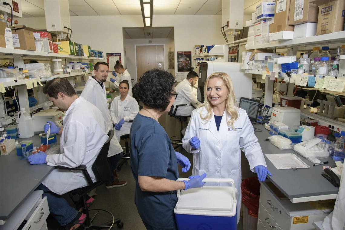 Melissa Herbst-Kralovetz, PhD, with her team inside the lab at the Phoenix Biomedical Campus.