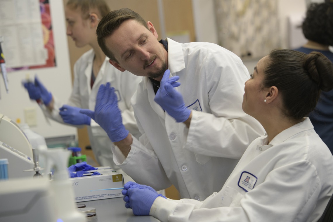 The Herbst-Kralovetz Lab makes its home on the Phoenix Biomedical Campus. Paweł Łaniewski, PhD, center, and Elisa Martinez, right, work to find the link between the vaginal microbiome and gynecologic cancer.