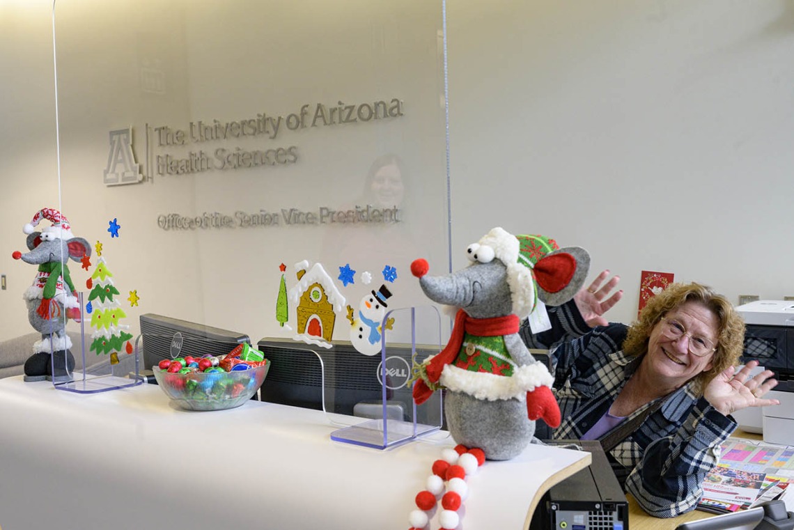 Deb Evano, senior office specialist, greets visitors to the Office of the Senior Vice President for the University of Arizona Health Sciences with holiday cheer and chocolate. 