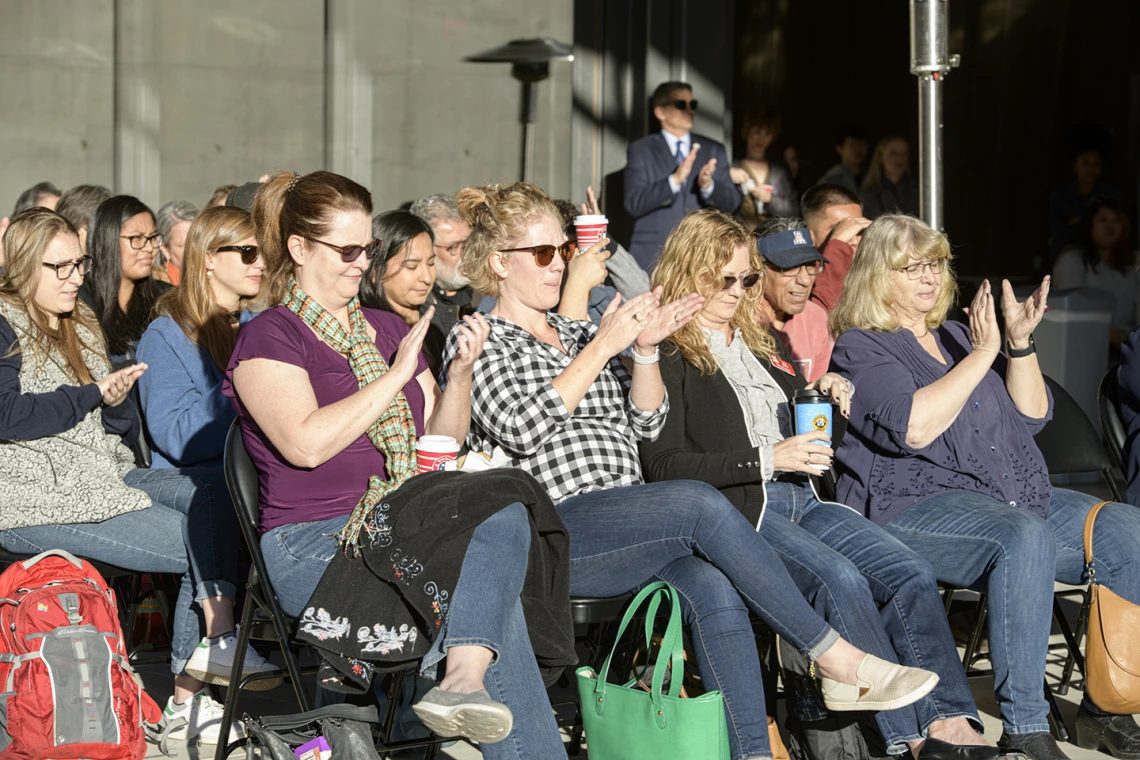 The audience applauds during the blessing ceremony.