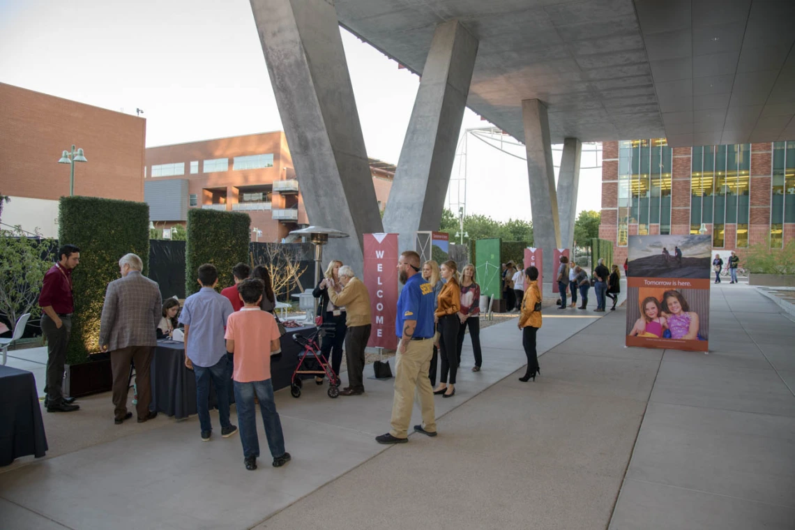 The porch space outside the first floor features tall, covered walkways and seating areas.