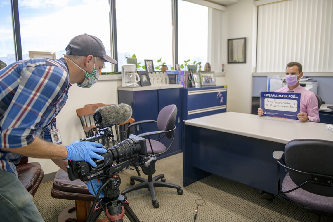 Roy Wageman, videographer in the Health Sciences Office of Communications, records Todd Vanderah, PhD, as he talks about the importance of wearing a mask. Vanderah is director of the Health Sciences Comprehensive Pain and Addiction Center.