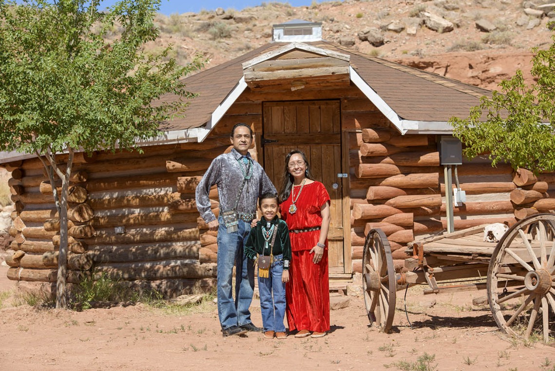Vanessa Jensen, MD, a University of Arizona College of Medicine – Tucson surgery alumna, with her husband and son in front of their family Hogan in Tuba City, Ariz. on the Navajo Nation.