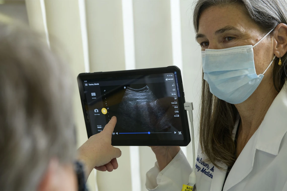 Julia Brown, MD, explains the images from the lung ultrasound to her standardized patient.