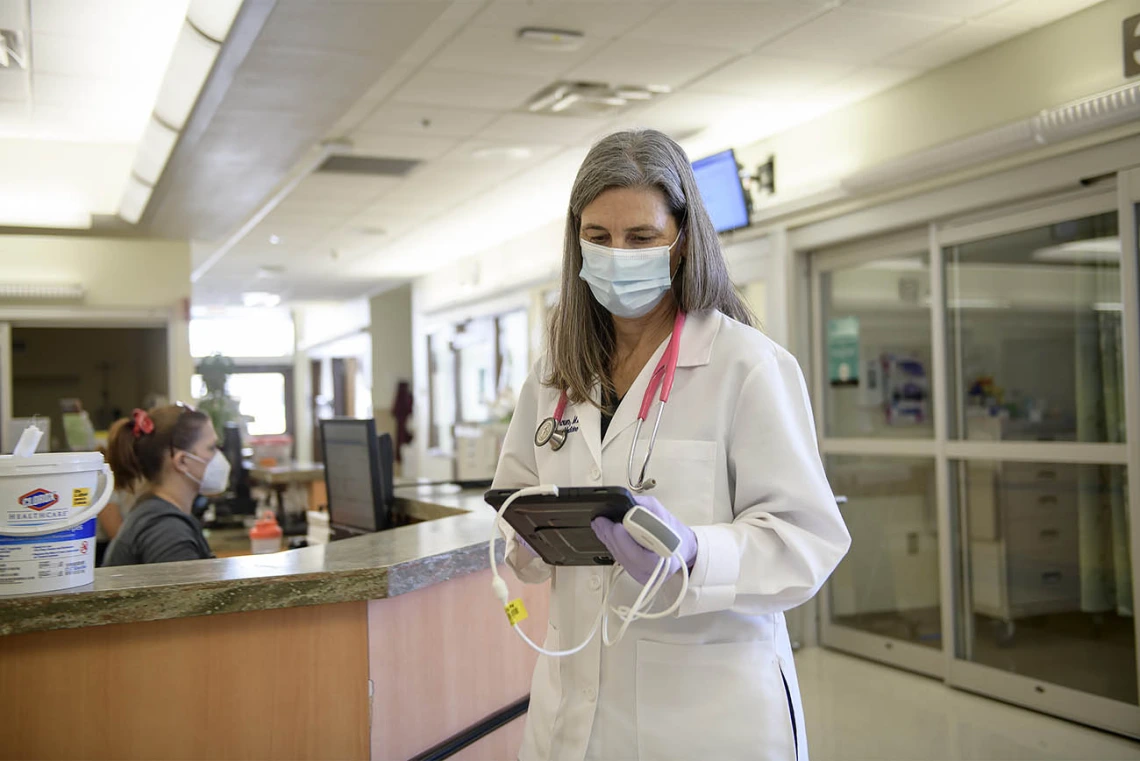 Viewing the results of a lung ultrasound, Julia Brown, MD, leaves the emergency department of the hospital. Evidence is mounting for the effectiveness of lung ultrasound in diagnosing and assessing the severity of coronavirus infections in emergency departments, where it could be an alternative to chest X-ray and CT chest scans when combined with a clinical examination.